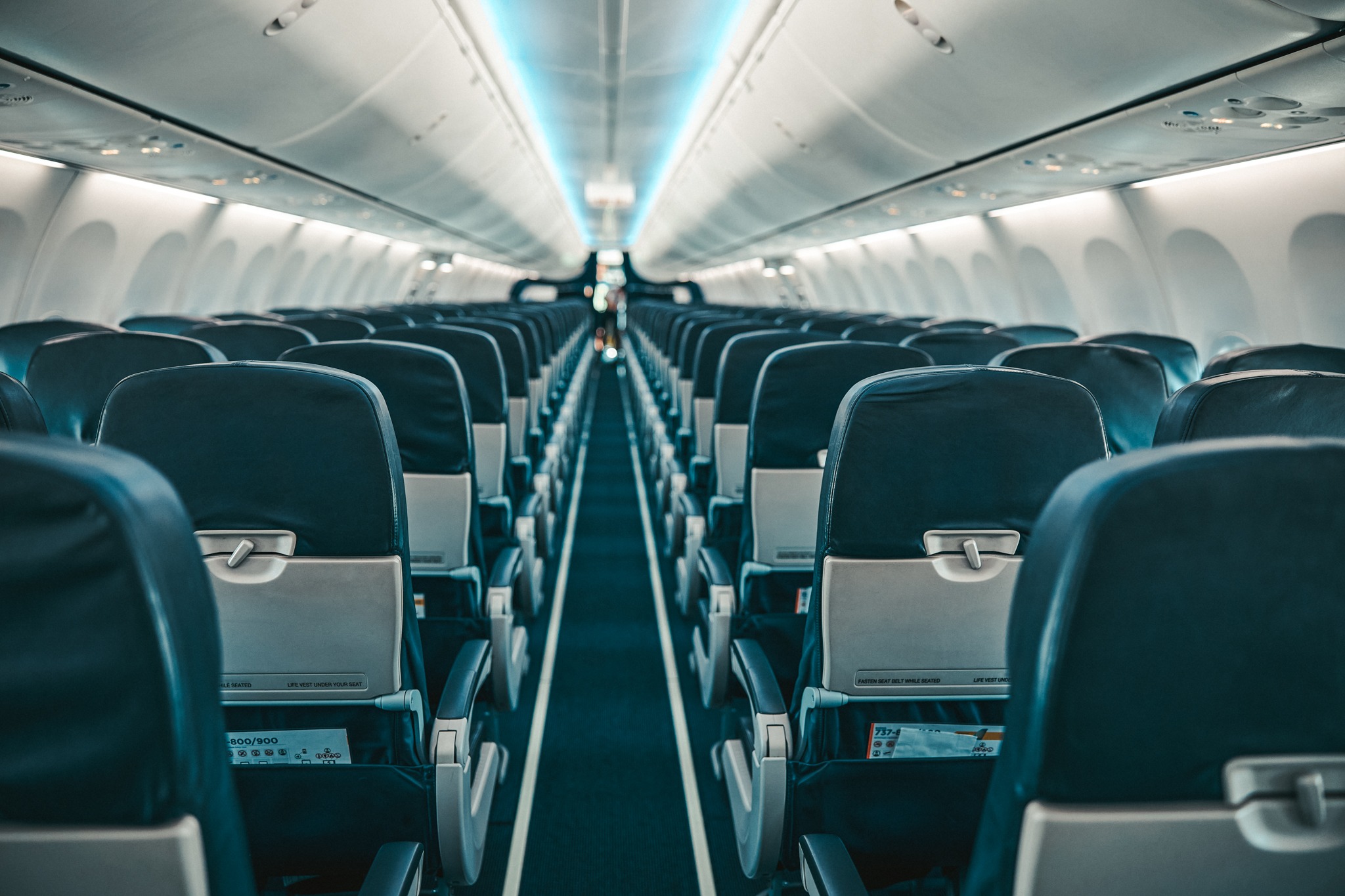 Airline passenger chairs and aisle in airplane cabin